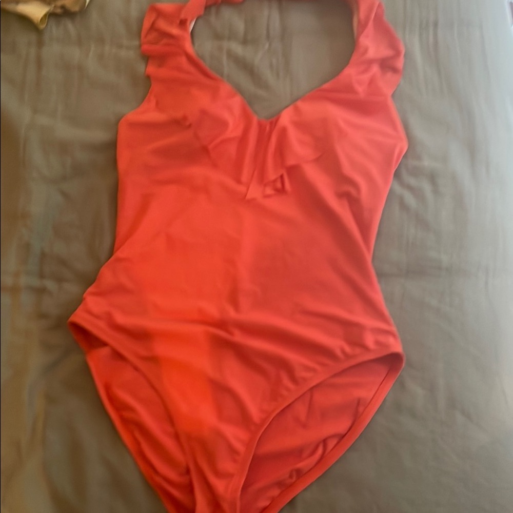 Gorgeous bright orange swimsuit with ruffled neckline